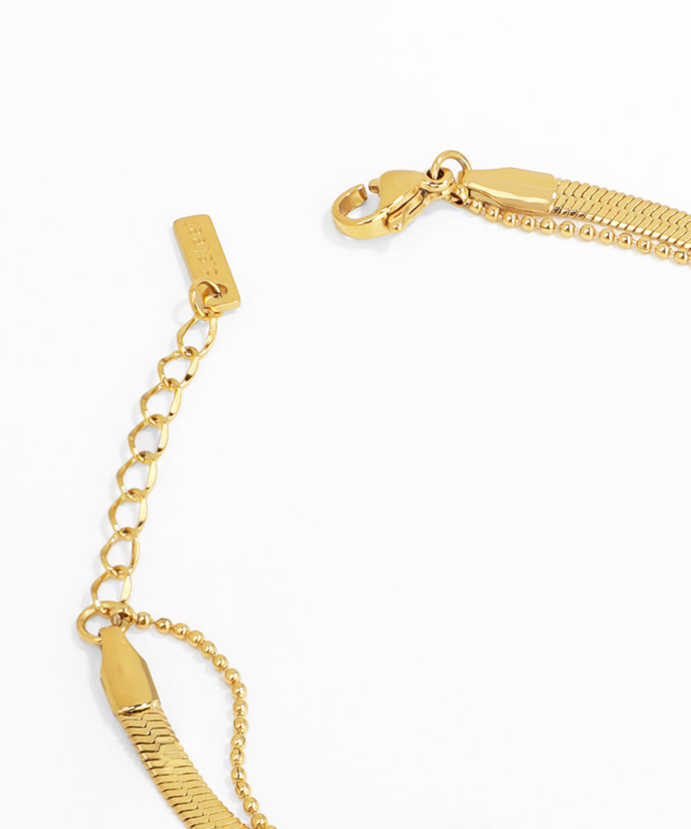 Gold bracelet with a clasp on a white background