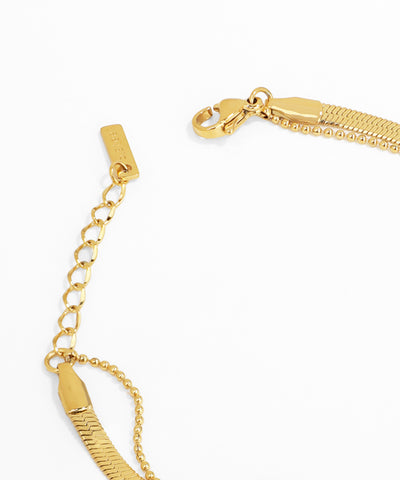 Gold bracelet with a clasp on a white background