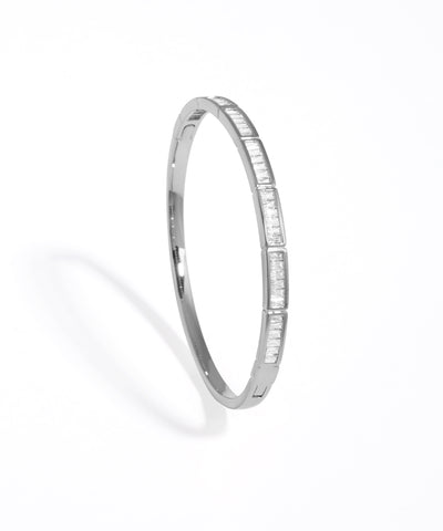 Silver bangle with small stones on a white background