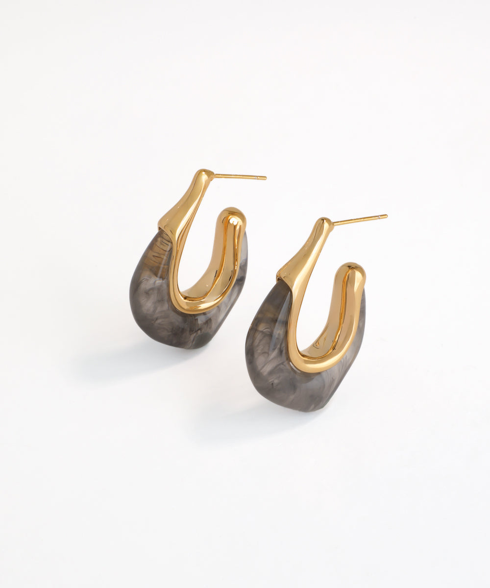 Pair of gold and gray hoop earrings on a white background