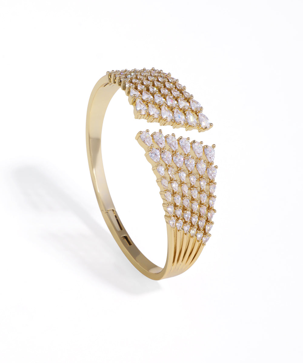 Gold-tone bracelet with sparkling multi-row teardrop cubic zirconia stones in an open-front design