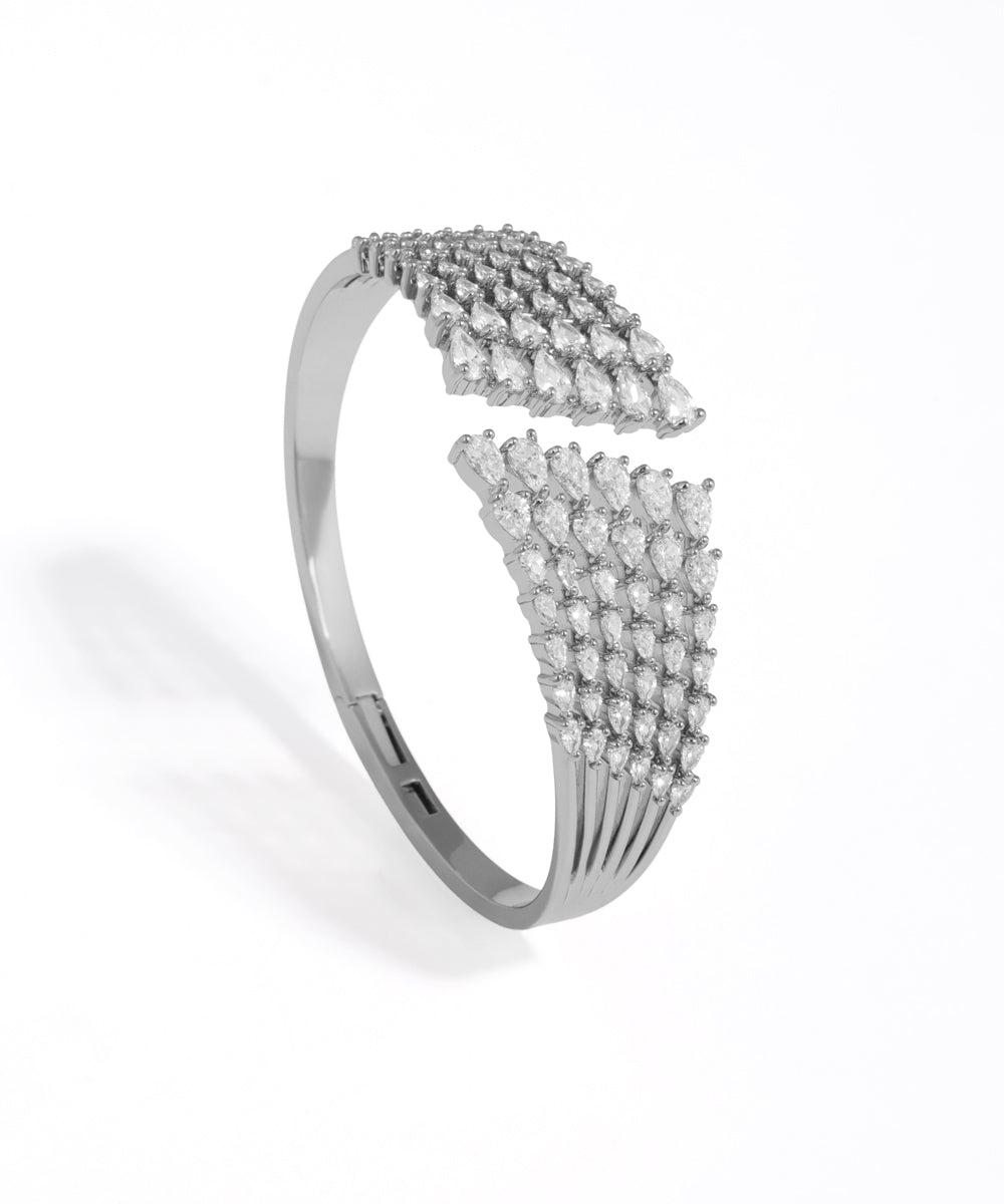 Silver bracelet with diamond accents on a white background