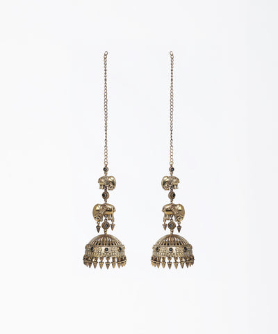 Pair of ornate earrings with intricate designs on a white background