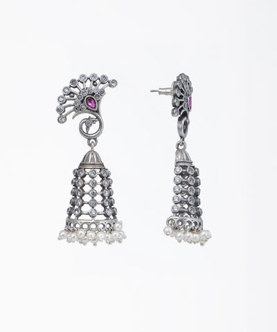 Pair of silver earrings with intricate designs on a white background
