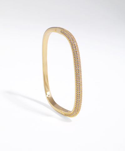 Gold-tone bracelet with pave set cubic zirconia on a curved contour surface