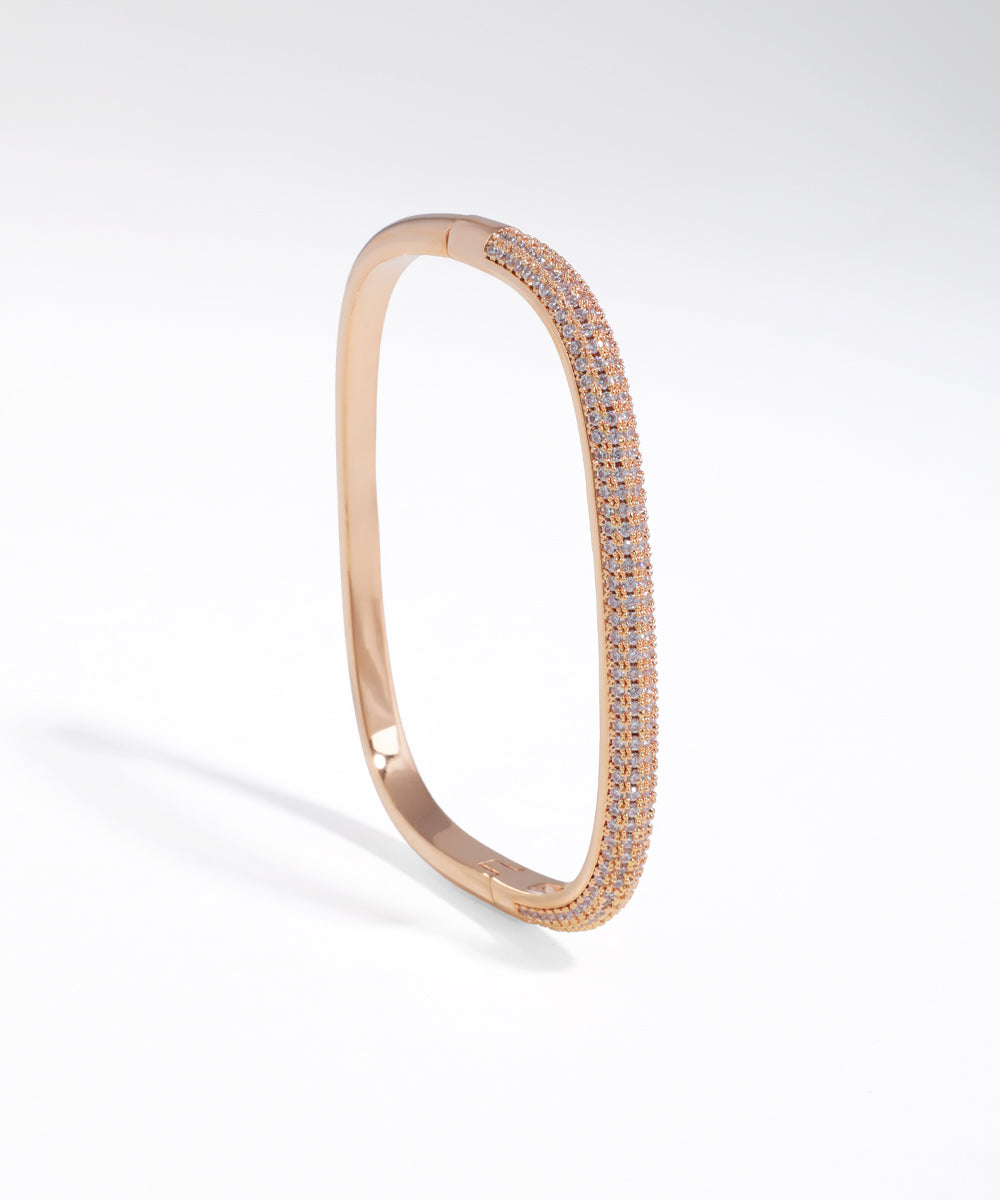 Rose gold bracelet with clear stones on a white background