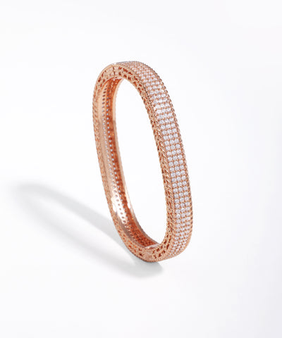Rose gold bracelet with clear stones on a white background