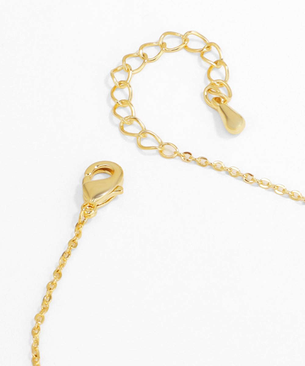 Gold chain necklace with clasp on a white background
