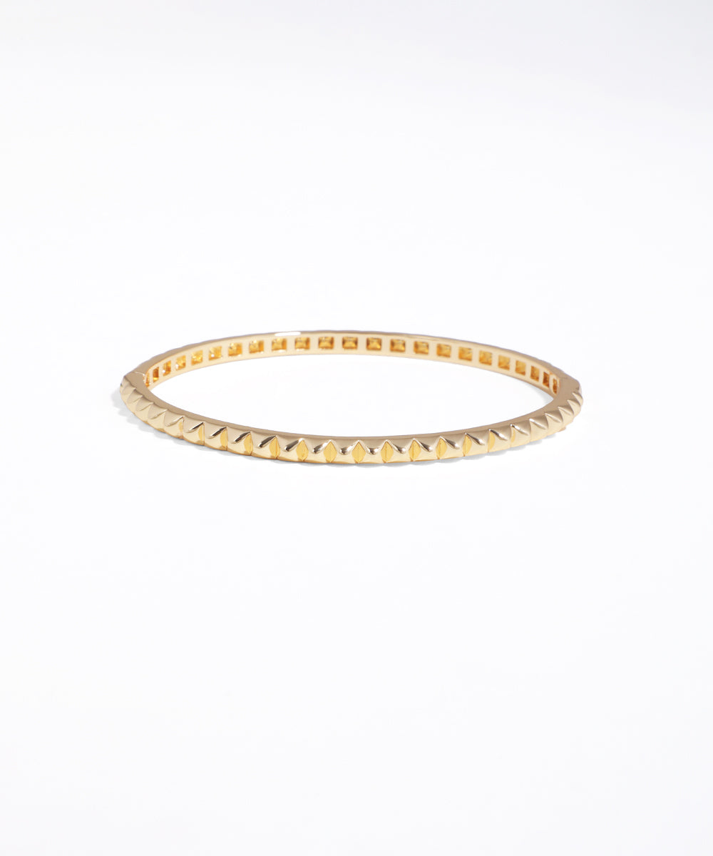 Gold bracelet on a white background
