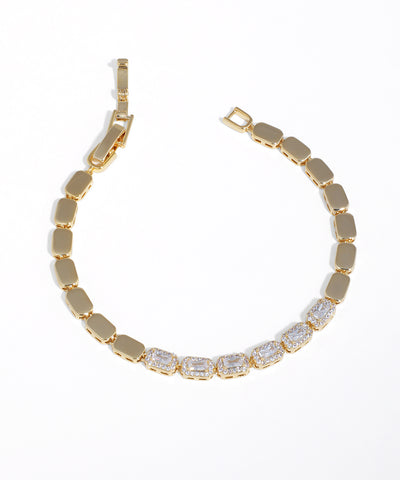 Gold-tone bracelet with alternating solid rectangular panels and emerald-cut CZ stones framed by smaller CZs.