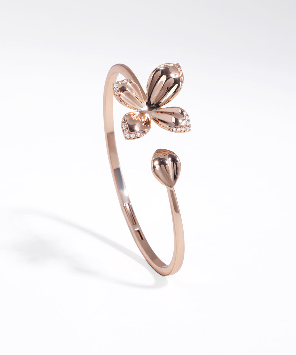 Rose gold butterfly-shaped ring on a white background