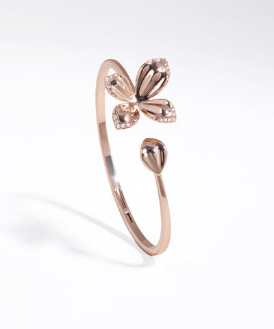 Rose gold butterfly-shaped ring on a white background
