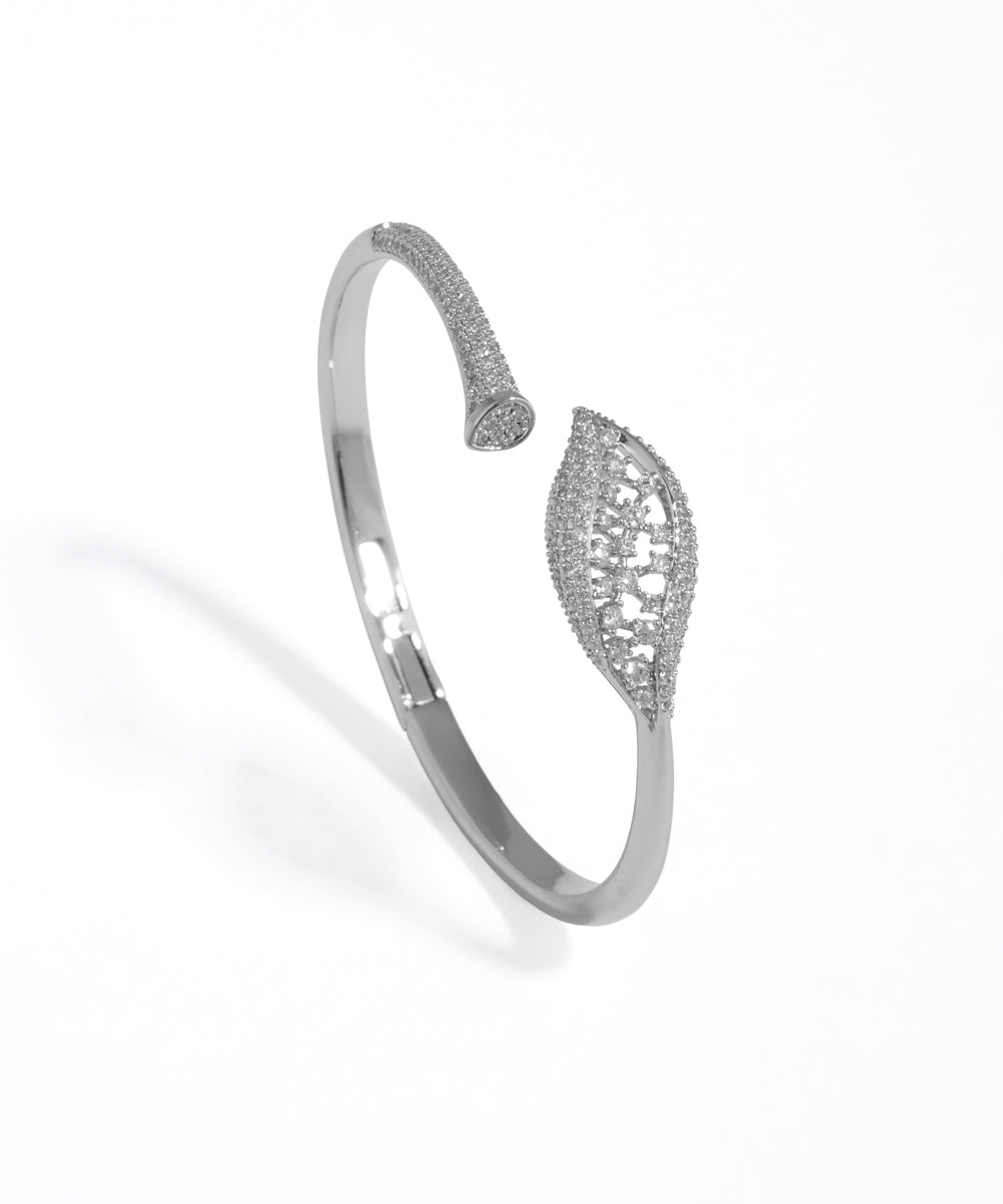 Silver bracelet with intricate design on a white background