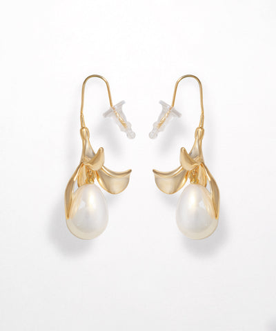 Gold earrings with pearl drops on a white background