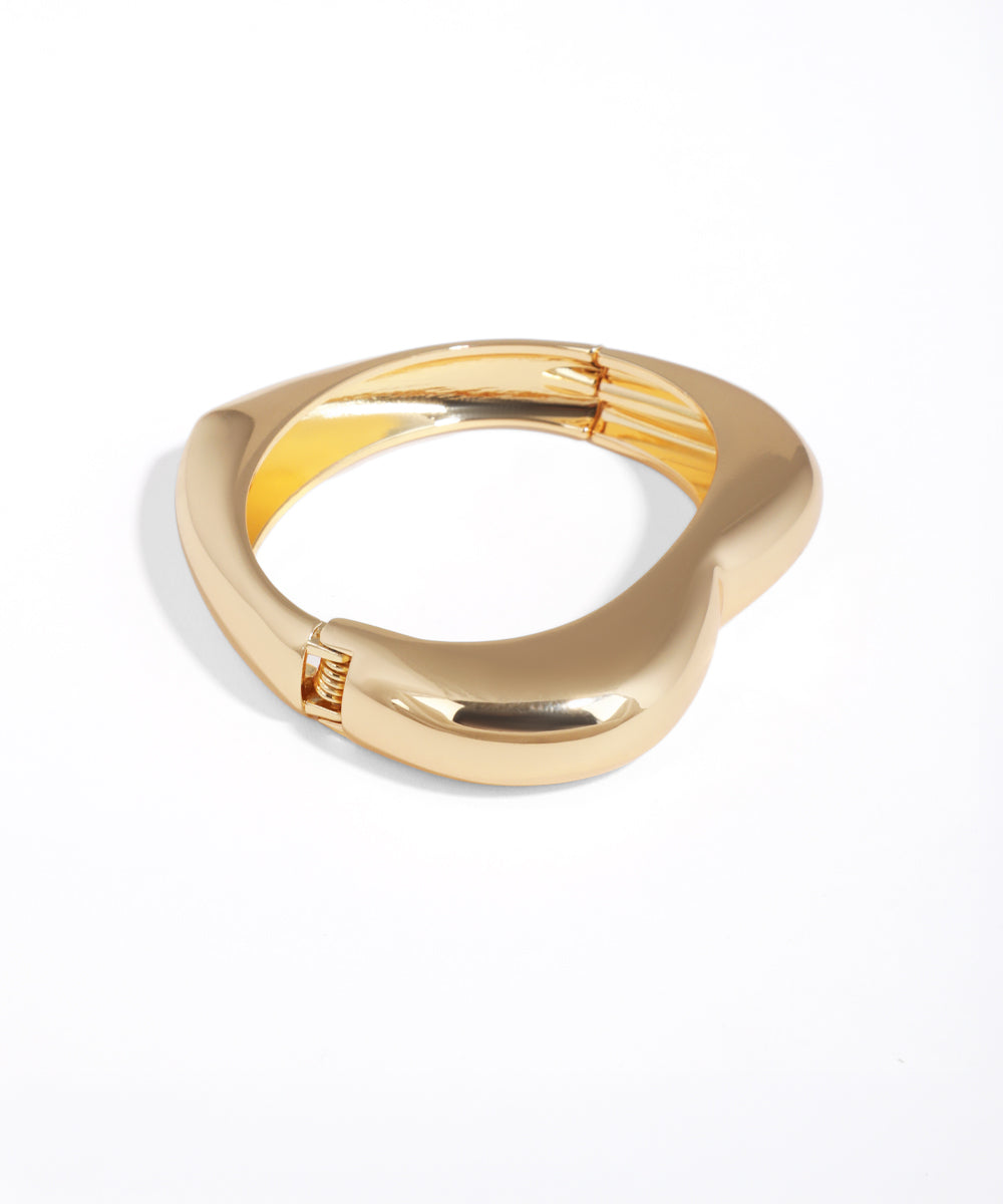 Gold ring with a unique design on a white background