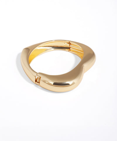 Gold ring with a unique design on a white background