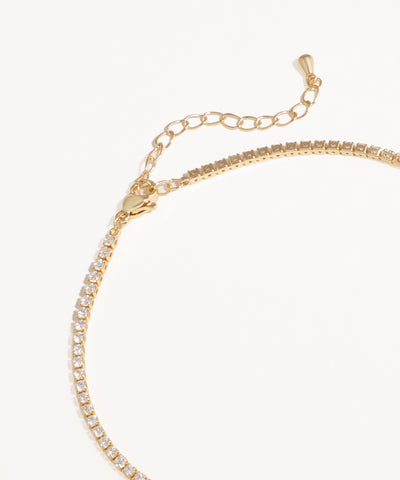 Gold Necklace with clear stones on a white background
