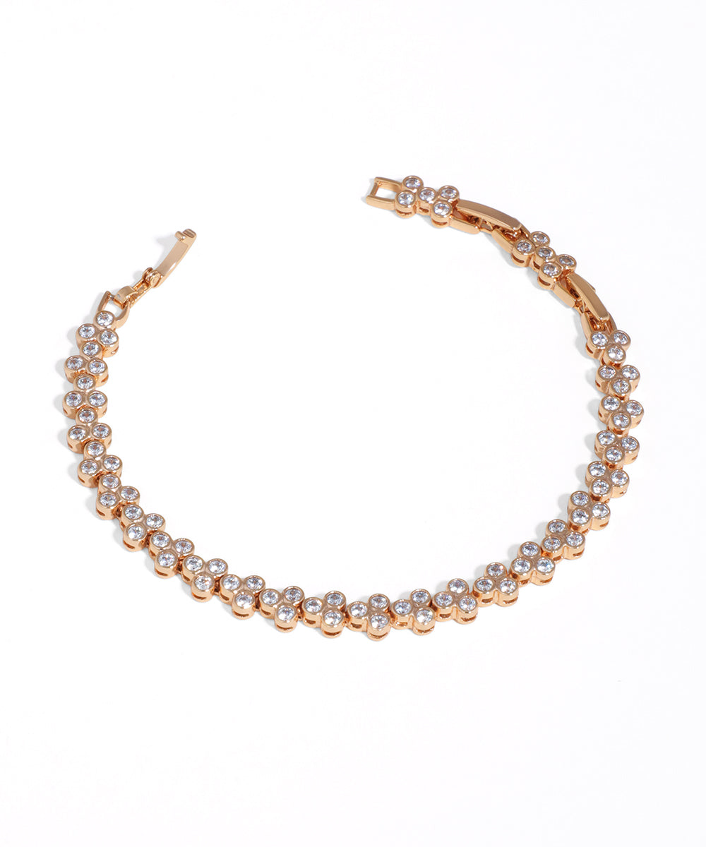 Rose-gold-tone bracelet with continuous clusters of clear cubic zirconia stones and a box clasp closure.
