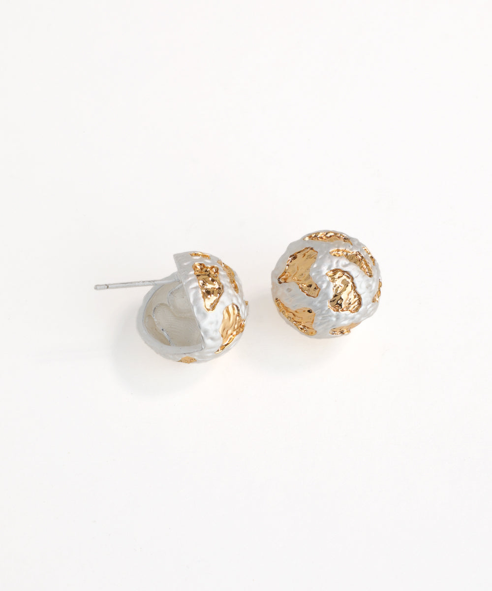 Pair of gold and silver spherical earrings on a white background
