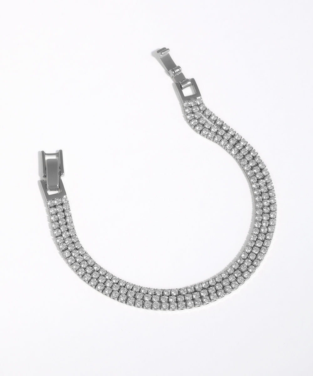 Silver bracelet with clear stones on a white background