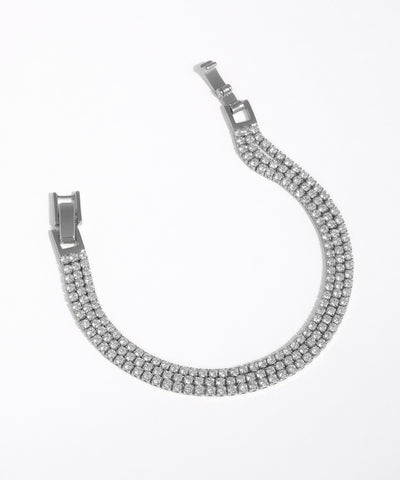 Silver bracelet with clear stones on a white background
