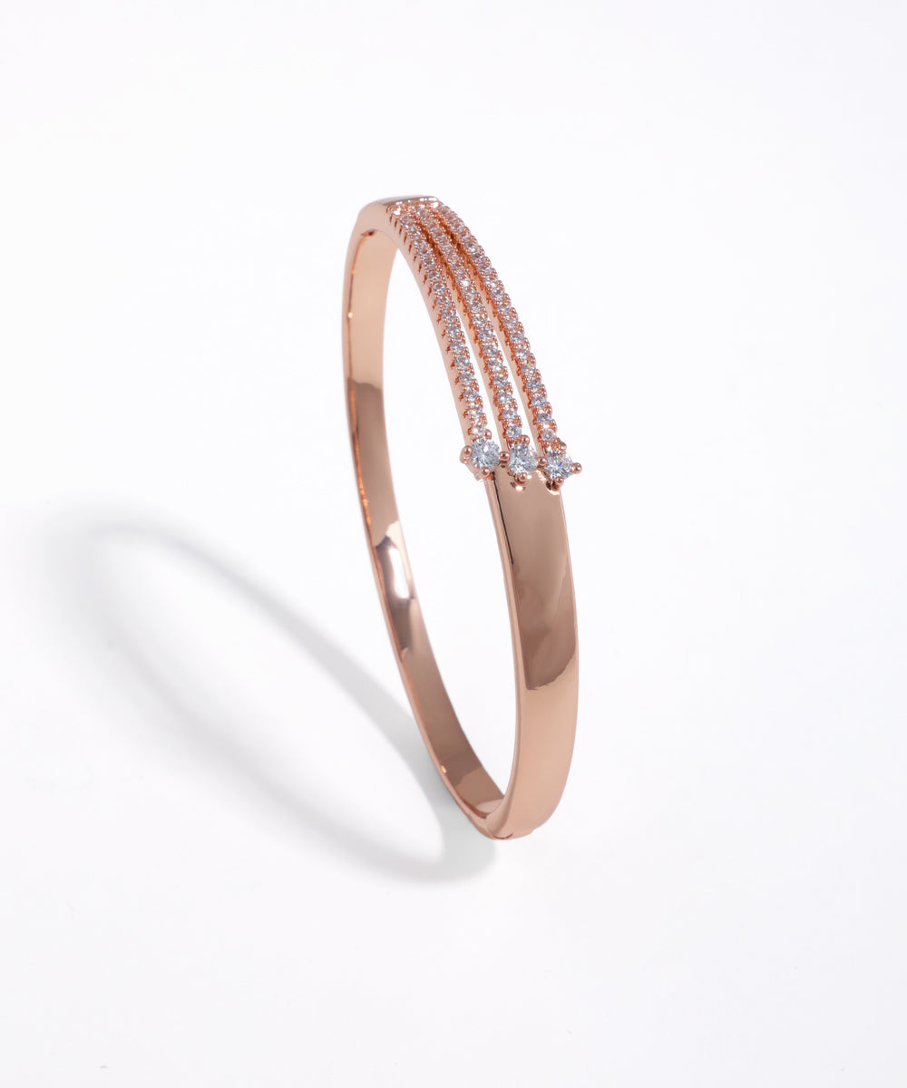 Rose-gold-tone cuff bracelet with three rows of clear stones and three accent stones.
