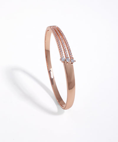 Rose-gold-tone cuff bracelet with three rows of clear stones and three accent stones.