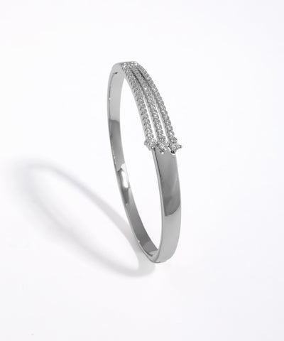 Silver bangle with small stones on a white background