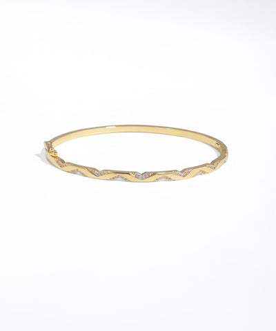 Gold bracelet with small diamonds on a white background