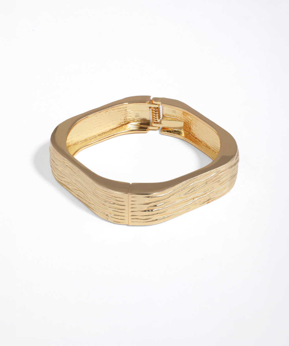 Gold bracelet on a white background