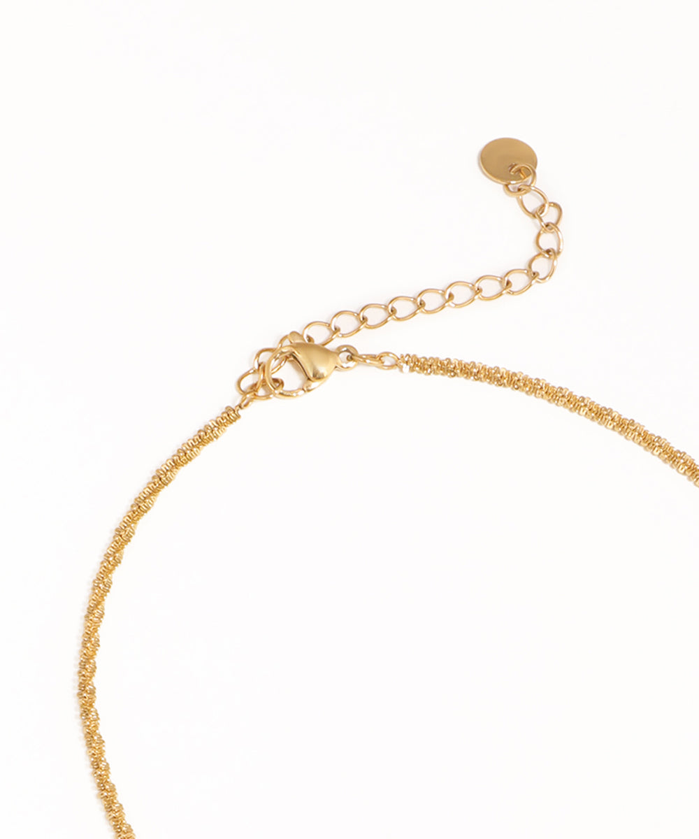 Gold bracelet on a white background