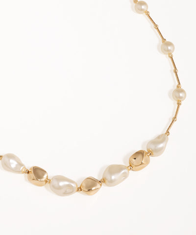 Necklace with gold and pearl beads on a white background