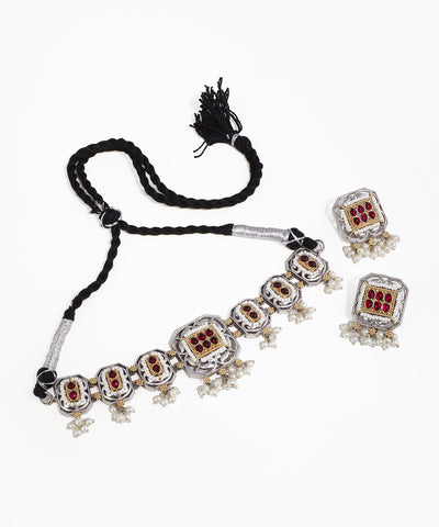 Necklace with matching earrings on a white background