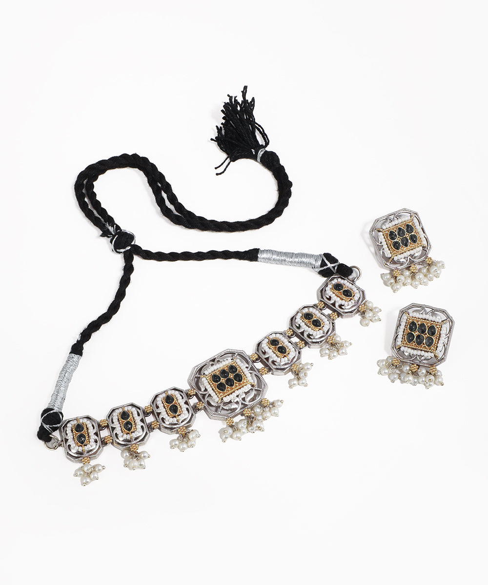 Necklace with matching earrings on a white background