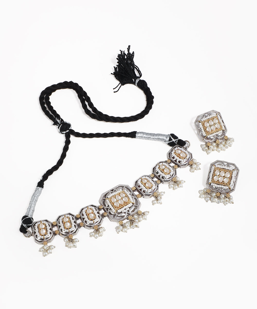 Necklace with tassel and matching earrings on a white background