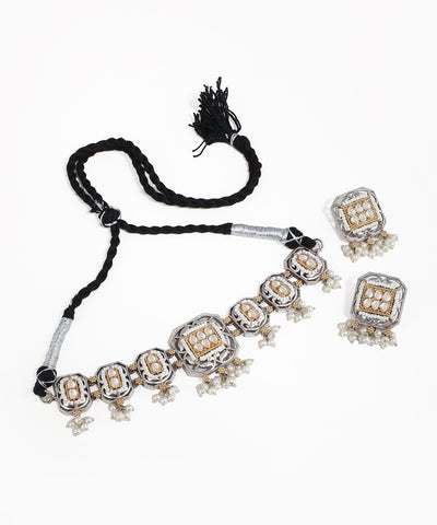 Necklace with tassel and matching earrings on a white background
