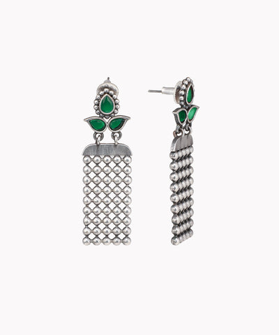 Pair of silver earrings with green gemstones on a white background