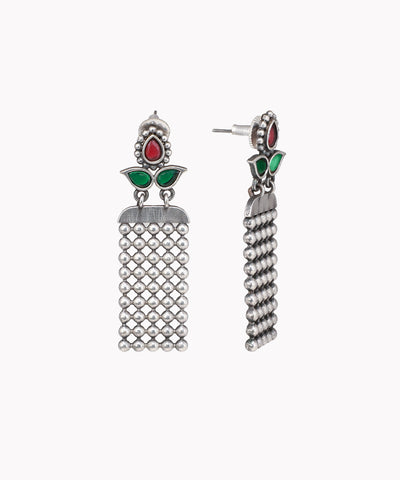 Pair of silver tassel earrings with green and red accents on a white background