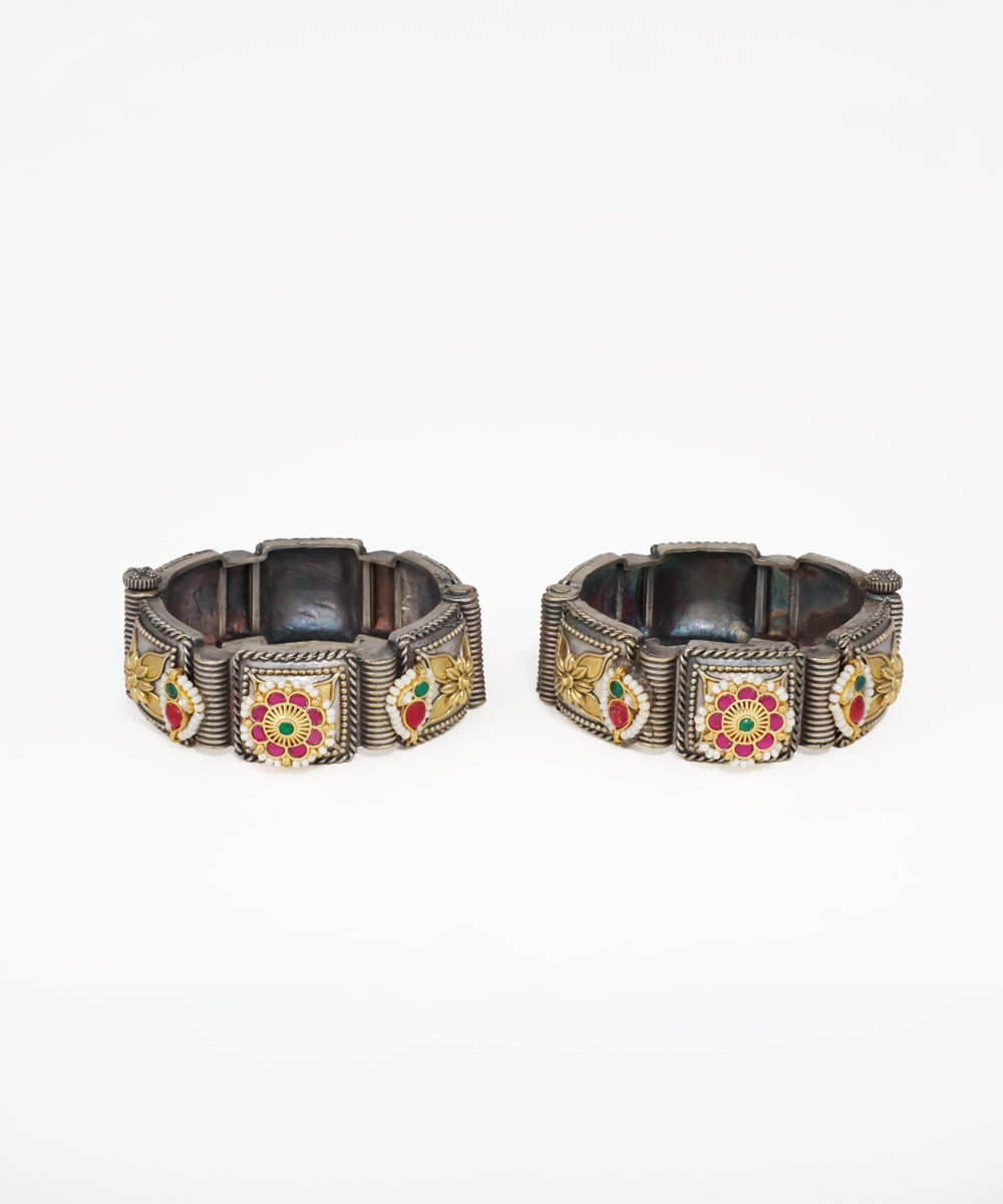 Oxidised finish bangle bracelet with gold-tone floral panels, red and green stones, and faux pearls