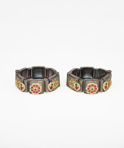 Oxidised finish bangle bracelet with gold-tone floral panels, red and green stones, and faux pearls