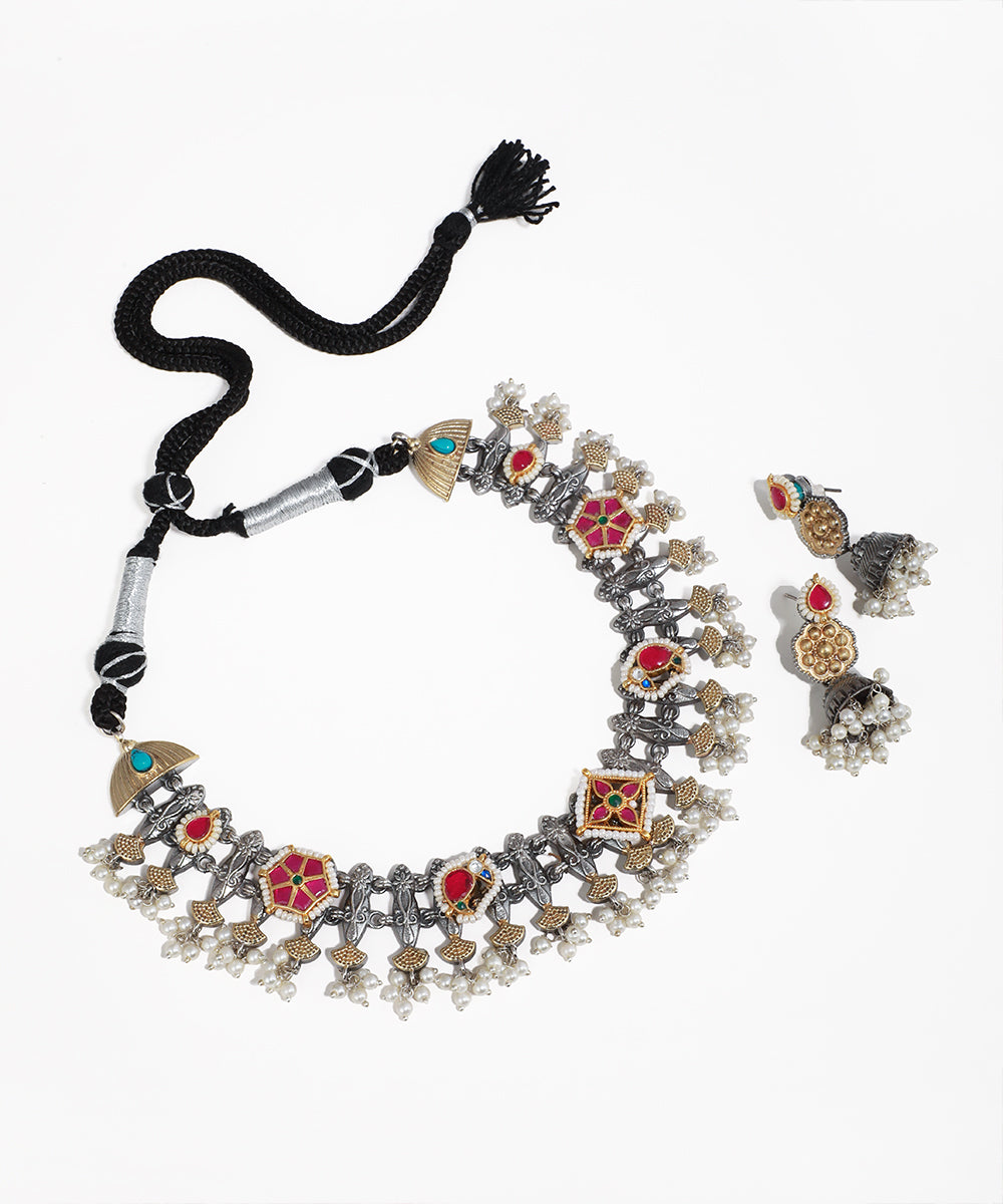Oxidised and gold-tone necklace set with colorful glass stones, faux pearls, and matching jhumka earrings.