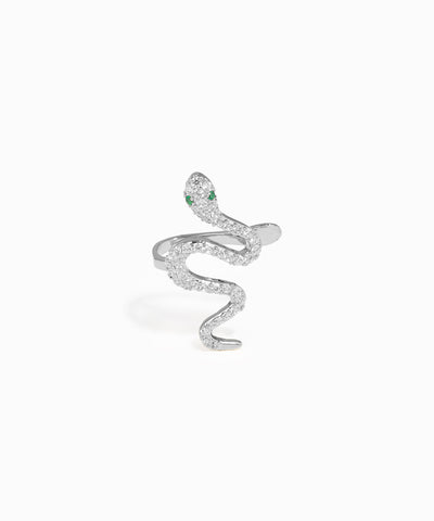 Silver snake-shaped earring with green gemstones on a white background