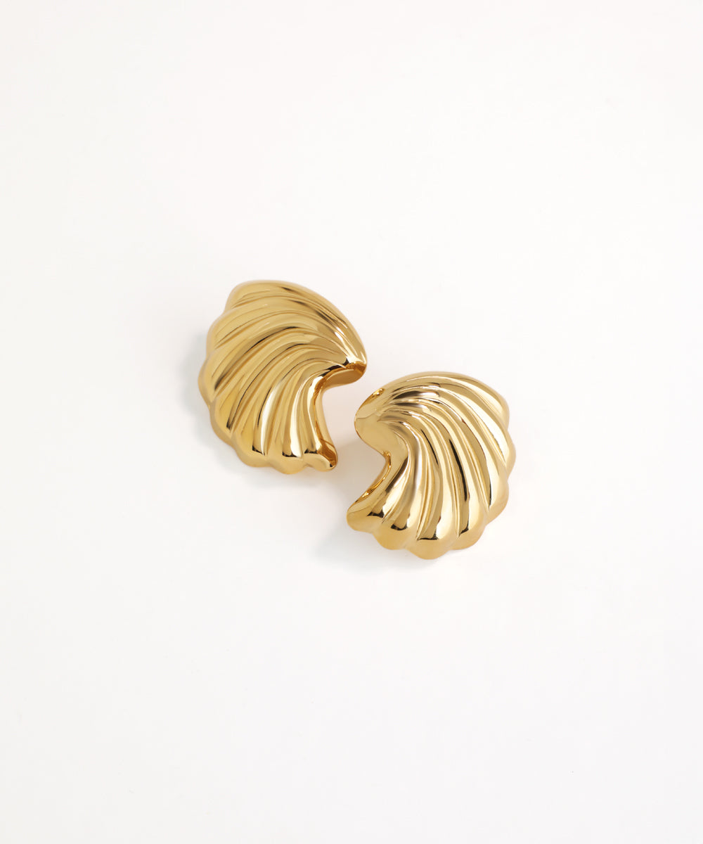 Pair of gold shell-shaped earrings on a white background