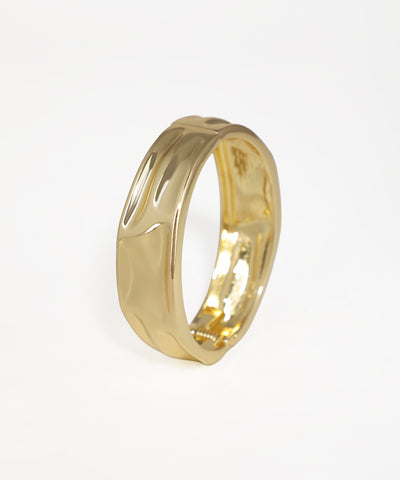 Gold-tone bangle kada with a wide, curved surface design