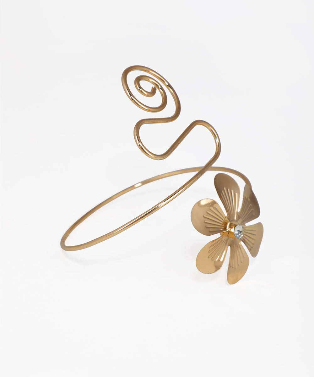 Gold bracelet with a floral design on a white background