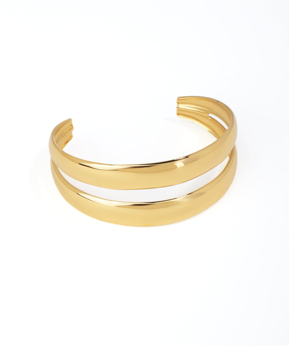 Gold bracelet with a white interior on a white background
