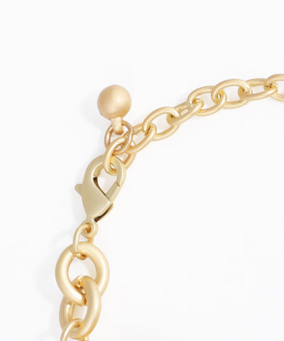Gold chain bracelet with a clasp on a white background
