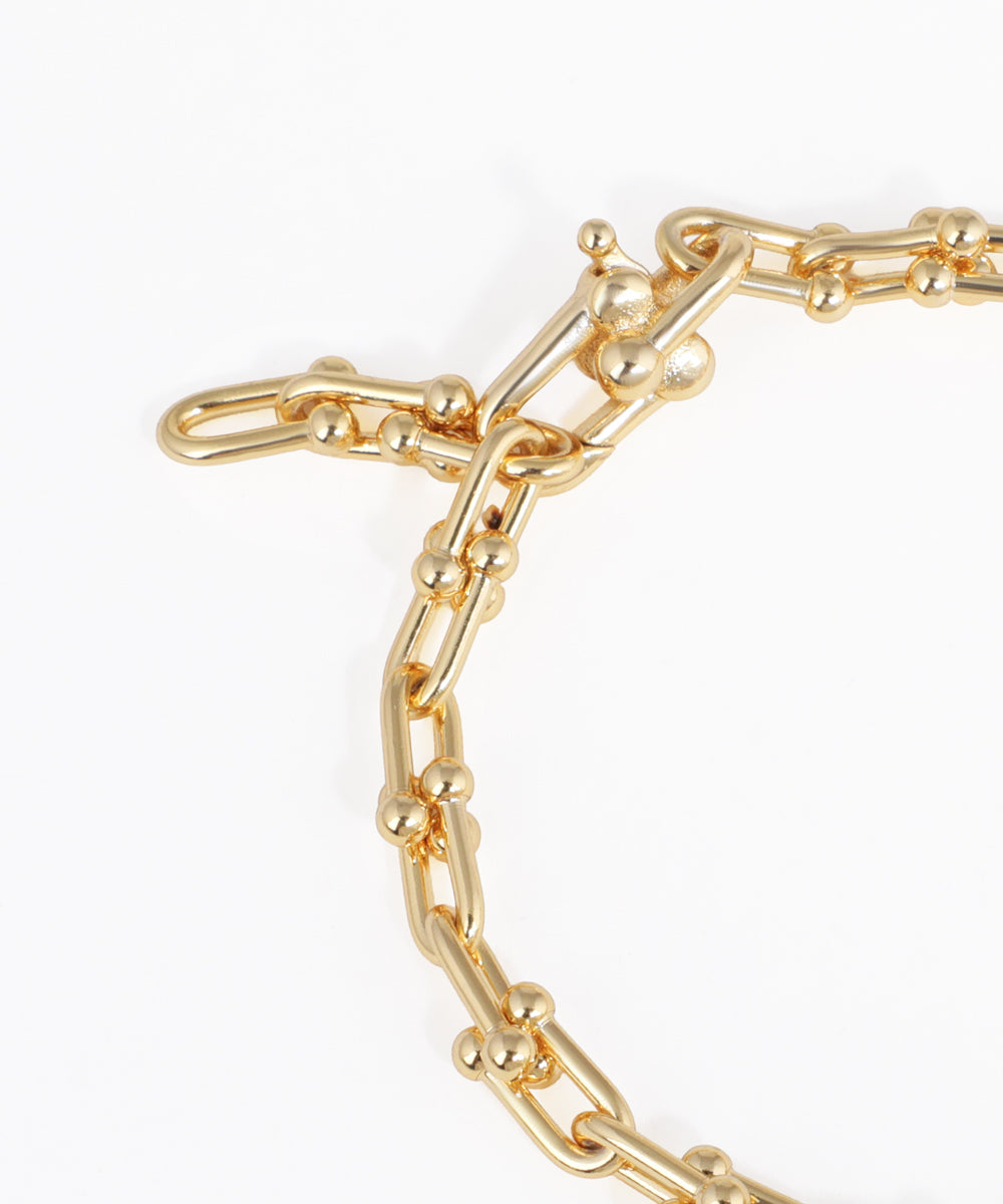Gold chain bracelet on a white background