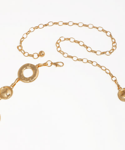 Gold chain bracelet with circular and spherical links on a white background