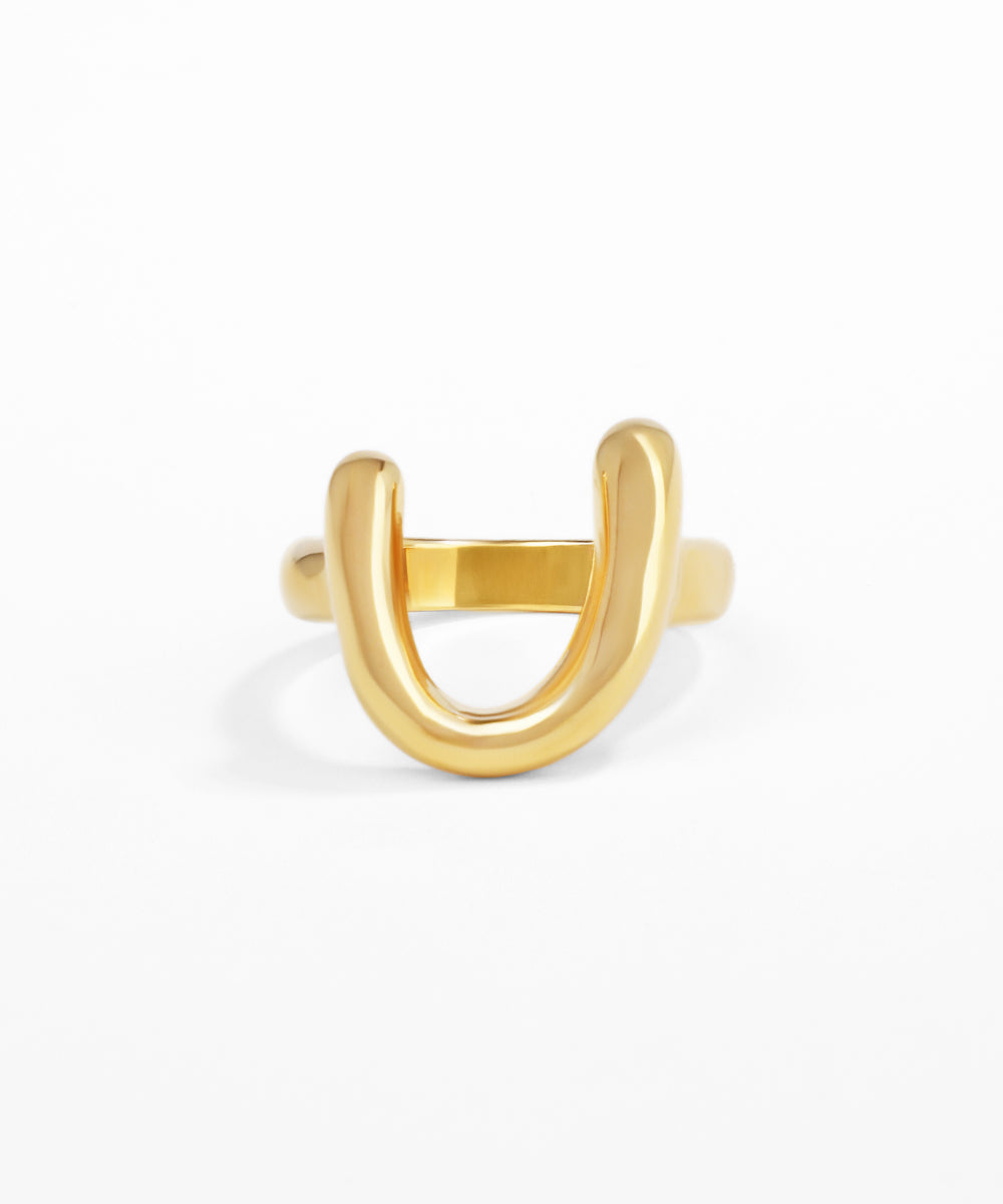 Gold U-shaped ring on a white background